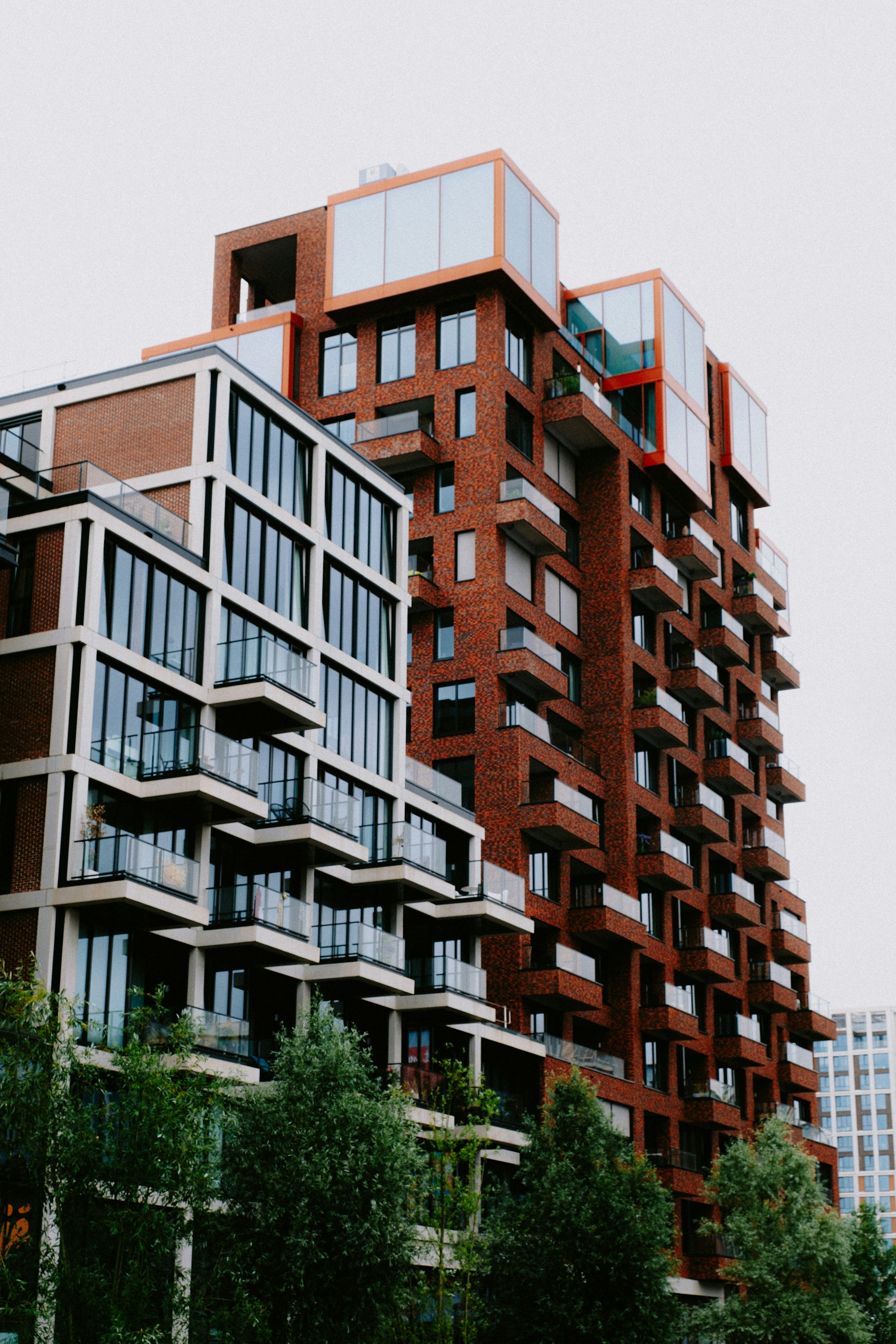 Modern residential architecture with brick façades and glass balconies